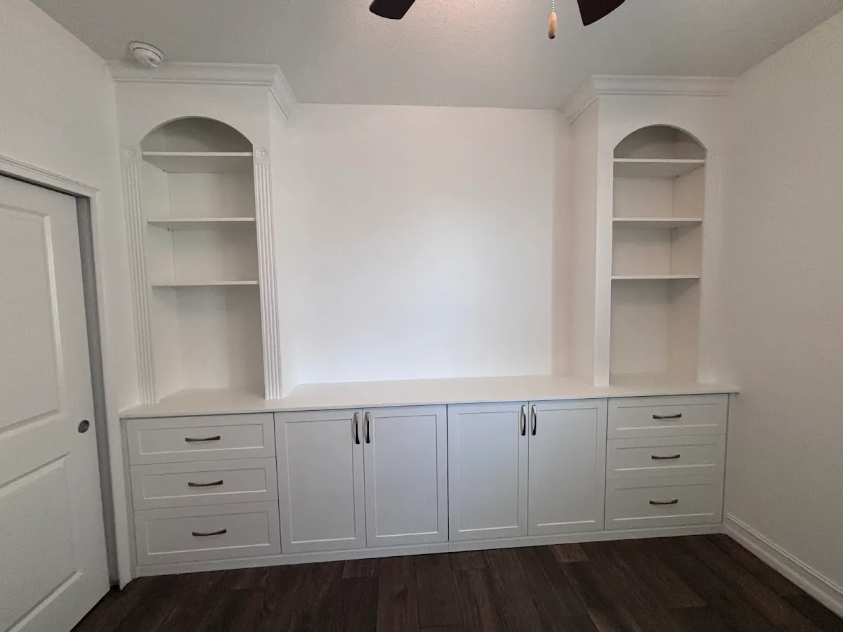 Built in entertainment unit arched shelves — custom storage designed and installed by Dream Closets