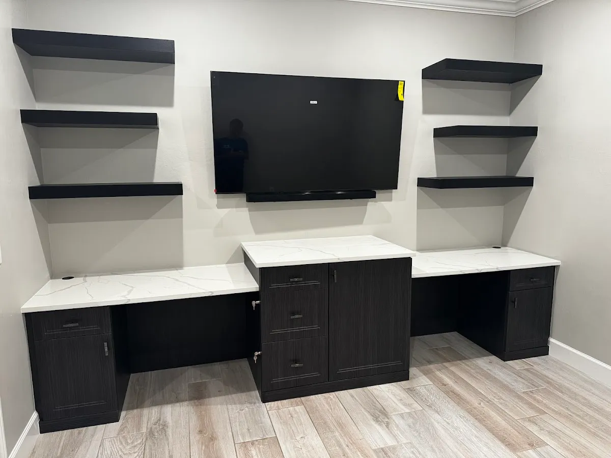 Custom dual-desk home office in espresso finish with floating shelves in Bradenton, FL
