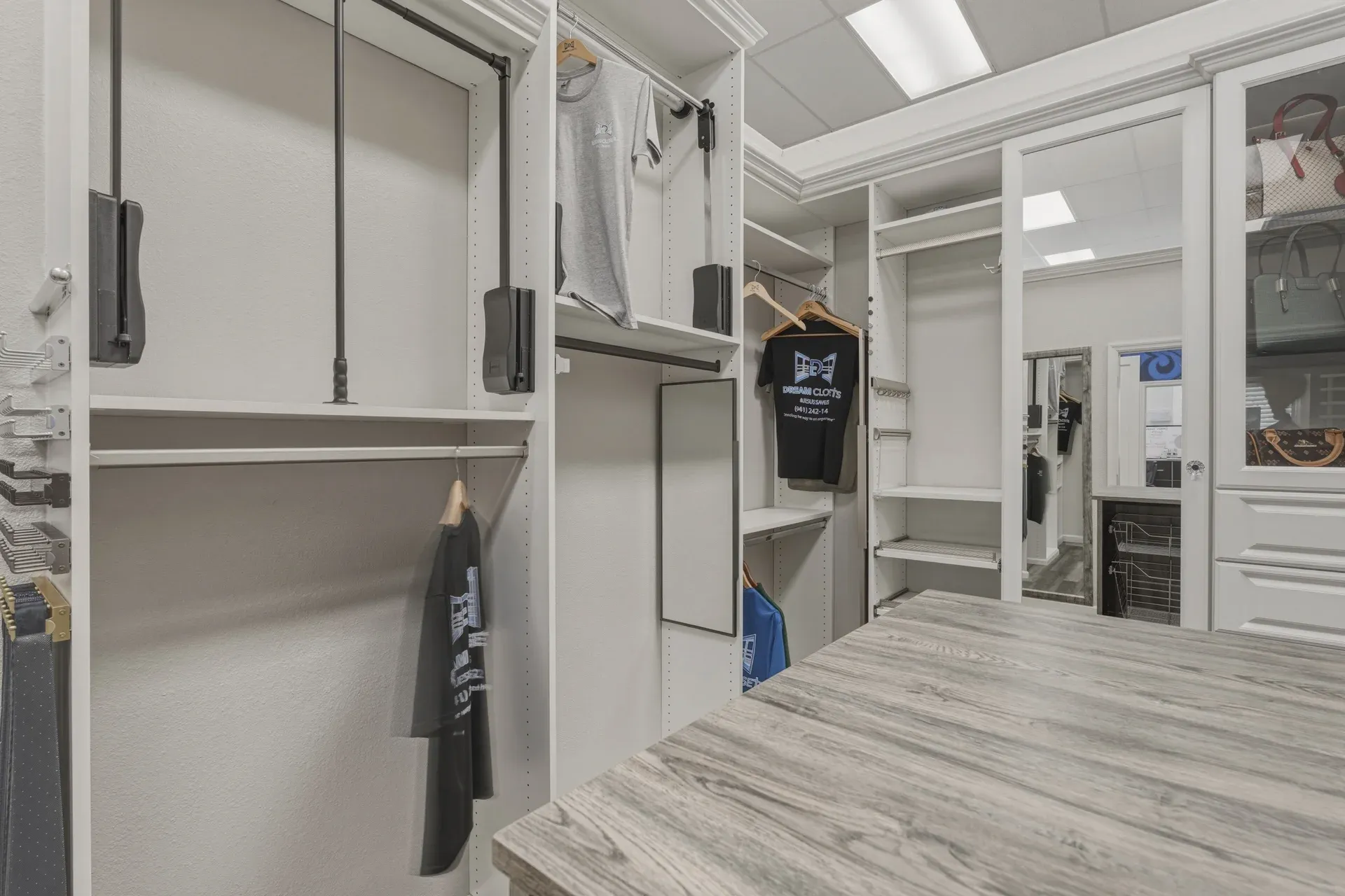 Dream closets showroom closet hanging rods display — custom storage designed and installed by Dream Closets in Bradenton, FL