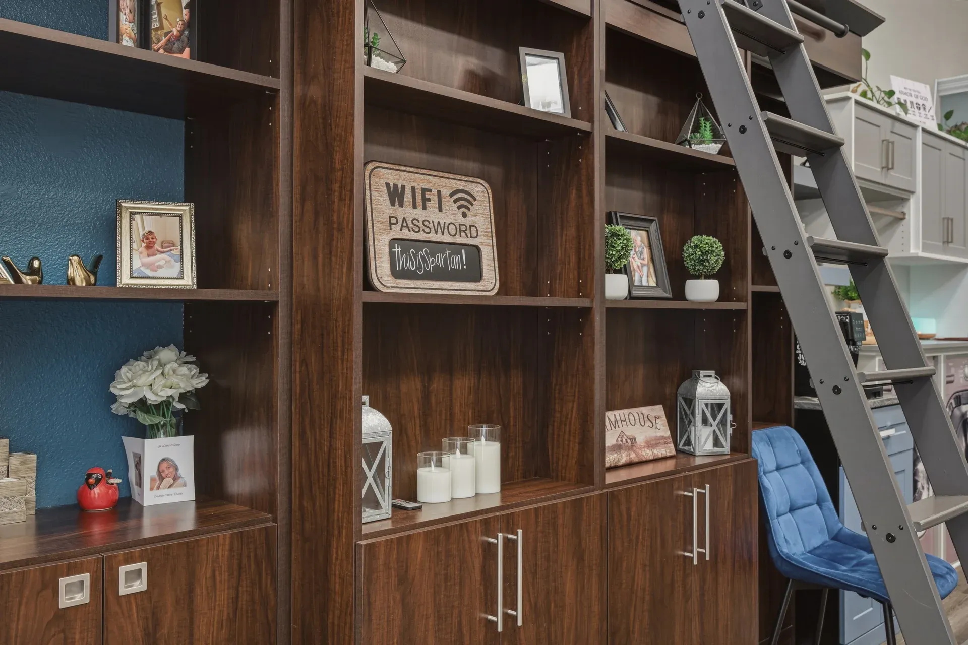 Dark walnut bookcase display with a rolling library ladder in the Bradenton showroom