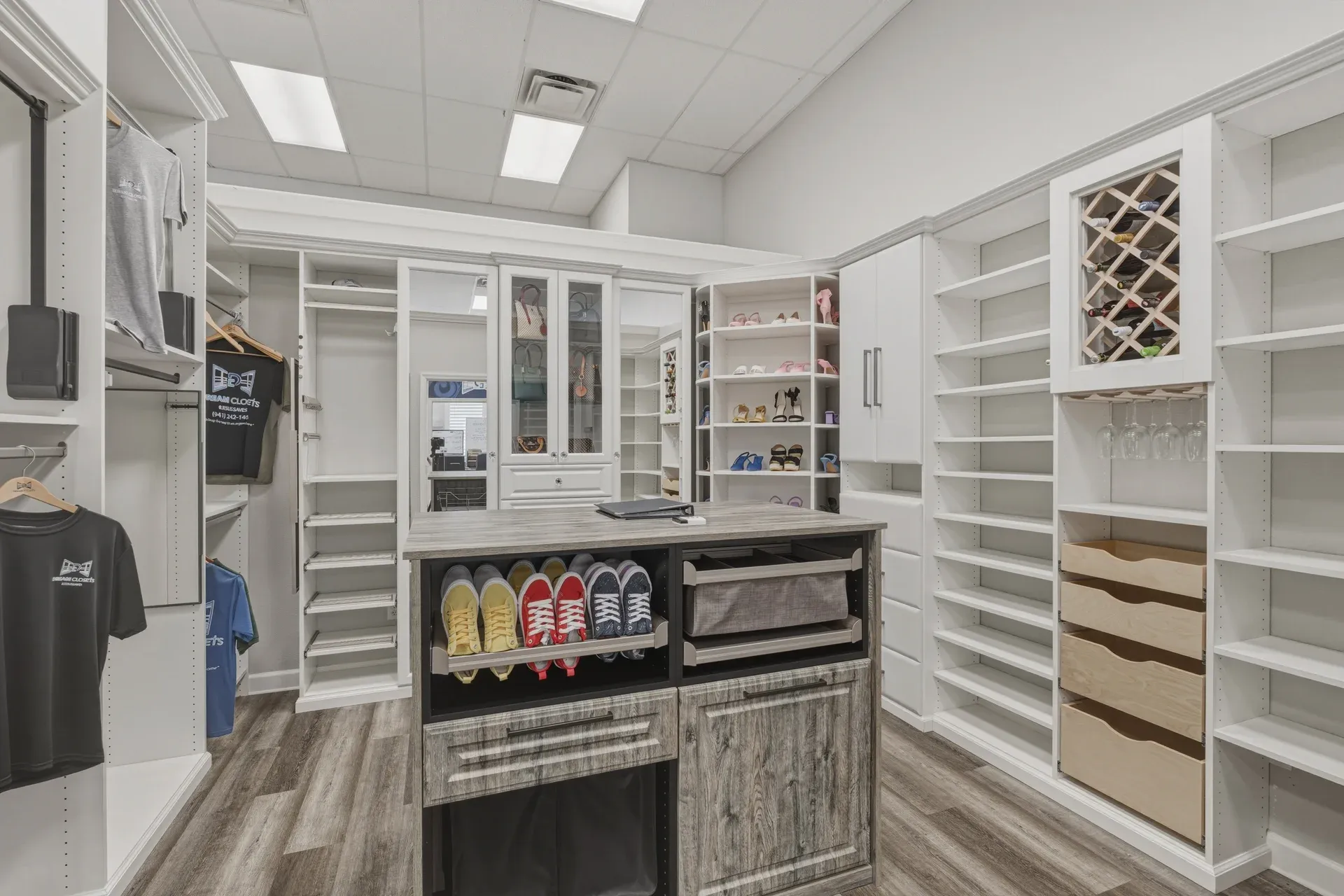Walk-in closet display with a centre island at the Dream Closets showroom in Bradenton, FL