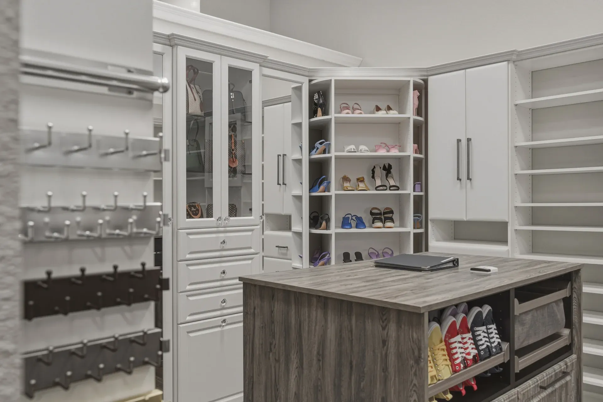 Showroom walk-in closet display with glass cabinets and shoe shelving in Bradenton, FL