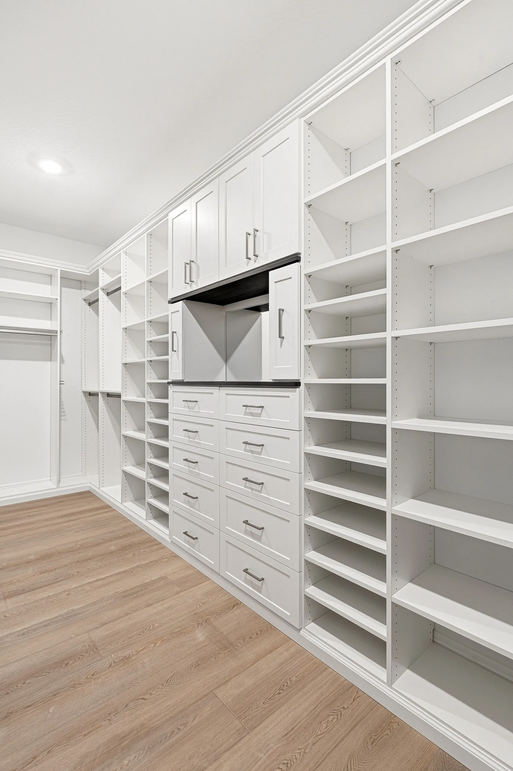 Luxury walk in closet floor to ceiling cabinetry — custom storage designed and installed by Dream Closets in Bradenton, FL