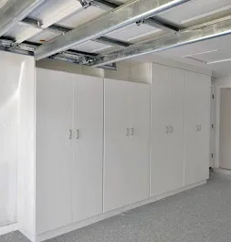 Full-height custom garage cabinets beneath an overhead storage track in Bradenton, FL