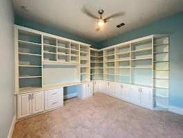 Wraparound home office built in desk bookshelves — custom storage designed and installed by Dream Closets in Longboat Key, FL